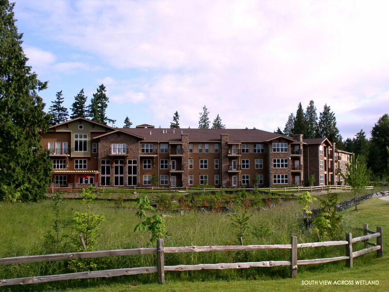 Exterior View of Main Building Across Wetland, Encircled by Mature Pines