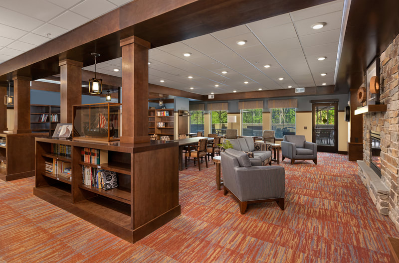 Lobby with Fireplace, Chairs, and Bookcases