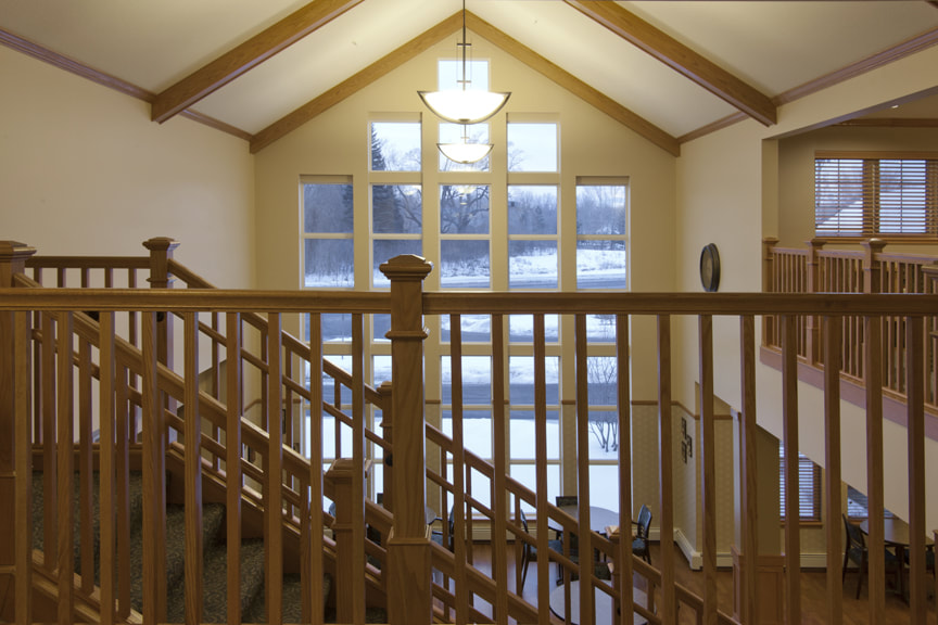 View of Community Room Window From Second Floor Through Wooden Railing