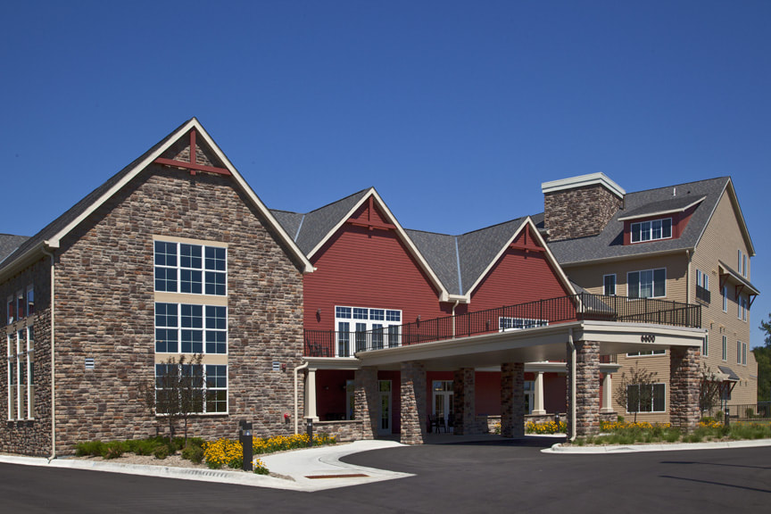 Exterior Entrance with Barn Red Siding and Stone Exterior