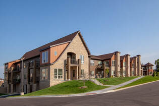St. Therese of Woodbury exterior entry to senior living residential wing, highlighting details such as brick columns along units.  
